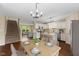 Inviting dining area with a modern chandelier and an adjacent open kitchen and living space at 518 Carthage Cir, Westfield, IN 46074