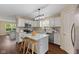 Modern kitchen featuring stainless appliances, an island with seating, and seamless integration with the living area at 518 Carthage Cir, Westfield, IN 46074