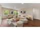 Bright living room with a sofa, two chairs, a coffee table, two stools and geometric area rug at 518 Carthage Cir, Westfield, IN 46074