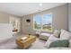 A living room with plush carpet, a sectional sofa, and large windows at 518 Carthage Cir, Westfield, IN 46074