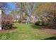 Expansive backyard with lush greenery, mature trees, and seating area perfect for outdoor enjoyment at 5277 Kingsley Dr, Indianapolis, IN 46220