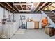 Unfinished basement with laundry, exposed beams, and ample space for storage or future customization at 5277 Kingsley Dr, Indianapolis, IN 46220