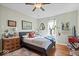 Comfortable bedroom with hardwood floors, a cozy bed, vintage furniture, and stylish decor at 5277 Kingsley Dr, Indianapolis, IN 46220