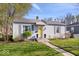 Charming single-story home featuring a well-maintained lawn, inviting yellow front door and blue shutters at 5277 Kingsley Dr, Indianapolis, IN 46220