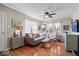 Inviting living room featuring hardwood floors, a ceiling fan, lots of light, and modern decor and furnishings at 5277 Kingsley Dr, Indianapolis, IN 46220