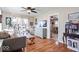 Inviting living room featuring hardwood floors, a ceiling fan, lots of light, and modern decor and furnishings at 5277 Kingsley Dr, Indianapolis, IN 46220