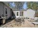 Relaxing patio with outdoor dining, lounge chairs, and mature shade trees providing an excellent outdoor space at 5277 Kingsley Dr, Indianapolis, IN 46220