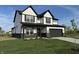 Charming two-story home with black trim, a gray garage door, and a well-manicured front yard at 5692 Coulter Way, Greenwood, IN 46143