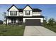 Charming two-story home with black trim, a gray garage door, and a well-manicured front yard at 5692 Coulter Way, Greenwood, IN 46143