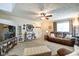 Spacious living room showcasing plush seating, decorative shelves, and neutral carpet at 591 Scotch Pine Dr, Greenwood, IN 46143