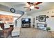 Comfortable living area with neutral carpeting, ceiling fan, and staircase at 591 Scotch Pine Dr, Greenwood, IN 46143