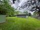 Lush backyard with a shed, showcasing the expansive green space, perfect for outdoor enjoyment and storage at 605 Queenswood Dr, Indianapolis, IN 46217