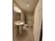 Functional bathroom with a pedestal sink and shower, designed for convenience and essential needs at 605 Queenswood Dr, Indianapolis, IN 46217