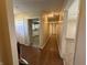 Hallway with vinyl flooring, doors, and views of the kitchen and living room at 605 Queenswood Dr, Indianapolis, IN 46217