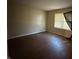 Spacious living room featuring wood floors and natural light from a window at 605 Queenswood Dr, Indianapolis, IN 46217