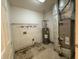 Utility room with a water heater, Bryant HVAC system, and wire shelving at 605 Queenswood Dr, Indianapolis, IN 46217