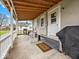 Covered back porch with outdoor furniture, ideal for entertaining or relaxing at 614 Elm St, Shelbyville, IN 46176