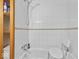 Tiled bathroom showing a bathtub with shower attachment and safety seat at 614 Elm St, Shelbyville, IN 46176