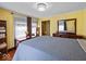 Inviting bedroom with a queen-sized bed, a decorative chandelier, and ample natural light at 614 Elm St, Shelbyville, IN 46176