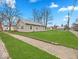 Well-maintained home with a spacious yard and a brick-lined sidewalk at 614 Elm St, Shelbyville, IN 46176