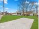 Home exterior with a large green yard and gravel parking spot at 614 Elm St, Shelbyville, IN 46176