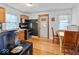 Bright kitchen with updated appliances, hardwood floors, and an adjacent dining area at 614 Elm St, Shelbyville, IN 46176