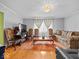 Well-lit living room featuring hardwood floors, couches, and decorative rug at 614 Elm St, Shelbyville, IN 46176