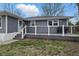 A spacious deck with black railings provides a relaxing outdoor space with access to the backyard at 6303 Bertha St, Indianapolis, IN 46241