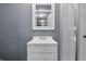 Bathroom features a modern vanity with mirror and a shower with glass doors at 6303 Bertha St, Indianapolis, IN 46241