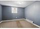 Cozy bedroom with a window and neutral carpeting at 6303 Bertha St, Indianapolis, IN 46241
