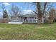 Charming single-story home with gray siding, white brick foundation and a well-maintained front lawn at 6303 Bertha St, Indianapolis, IN 46241