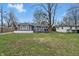 Charming single-story home with gray siding, white brick foundation and a well-maintained front lawn at 6303 Bertha St, Indianapolis, IN 46241