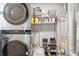 Functional laundry area with modern washer/dryer, shelving, and utility space at 6303 Bertha St, Indianapolis, IN 46241
