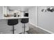 Stylish bar with seating overlooks the kitchen, creating an inviting open-concept space at 6303 Bertha St, Indianapolis, IN 46241