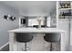 Stylish bar with seating overlooking the neutral-toned living area, creating an inviting open-concept space at 6303 Bertha St, Indianapolis, IN 46241
