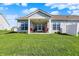 Backyard view of the house featuring a covered patio with outdoor seating at 6625 Ferguson Dr, Whitestown, IN 46075