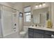 Well-lit bathroom featuring a shower-tub combo and a vanity with a mirror at 6625 Ferguson Dr, Whitestown, IN 46075