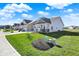 A row of homes showcasing well-maintained lawns and landscaping in a suburban neighborhood at 6625 Ferguson Dr, Whitestown, IN 46075