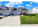 Charming home with a well-manicured lawn, covered porch with chairs, and a two-car garage at 6625 Ferguson Dr, Whitestown, IN 46075