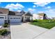 Beautifully landscaped front yard with a spacious driveway and inviting covered porch in a residential neighborhood at 6625 Ferguson Dr, Whitestown, IN 46075