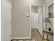 Neutral hallway showcasing wood-look floors, leading to other rooms in the home at 6625 Ferguson Dr, Whitestown, IN 46075