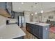 Open kitchen features gray cabinets, stainless appliances, quartz countertops, and a central island at 6625 Ferguson Dr, Whitestown, IN 46075