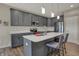 Beautiful kitchen features gray cabinetry, stainless steel appliances, quartz countertops, and a large island at 6625 Ferguson Dr, Whitestown, IN 46075