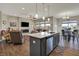 Open-concept kitchen flows into the living room and dining area, perfect for entertaining guests at 6625 Ferguson Dr, Whitestown, IN 46075