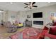 Inviting living room featuring a fireplace, ceiling fan, stylish furniture, and natural light at 6625 Ferguson Dr, Whitestown, IN 46075