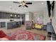Open-concept living space with a fireplace, and adjacent modern kitchen with breakfast bar seating at 6625 Ferguson Dr, Whitestown, IN 46075