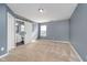 Spacious carpeted bedroom with ensuite bathroom featuring modern sliding barn door and natural light at 7115 N Lyndhurst Xing, McCordsville, IN 46055