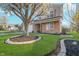 Inviting home exterior with blooming tree, wood shutters, and well-kept lawn at 7115 N Lyndhurst Xing, McCordsville, IN 46055