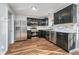Modern kitchen with stainless steel appliances, dark cabinetry, and a decorative tile backsplash at 7115 N Lyndhurst Xing, McCordsville, IN 46055