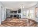A modern eat-in kitchen with stainless steel appliances, dark cabinetry, and stylish wood flooring at 7115 N Lyndhurst Xing, McCordsville, IN 46055